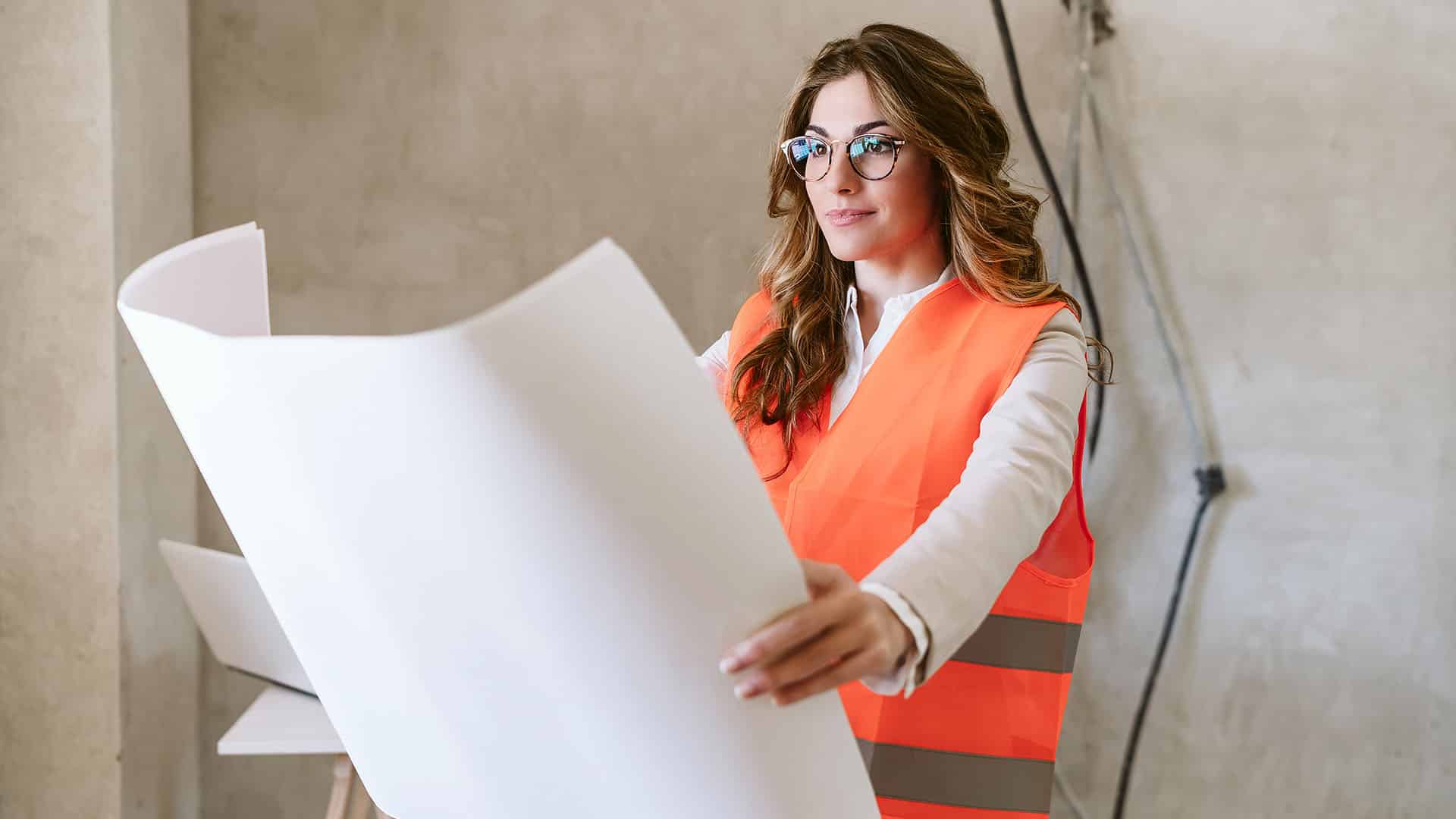 Architect evaluating floor plan on site