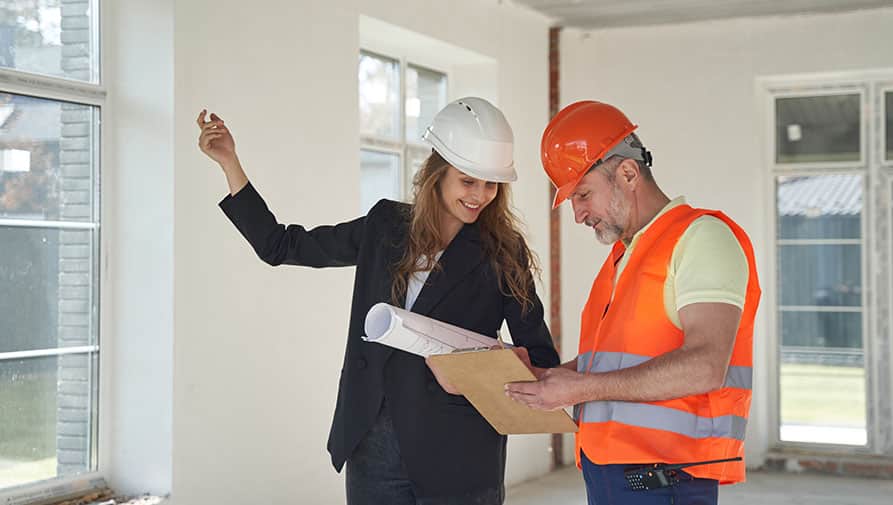 Interior designer supervising contractor on site