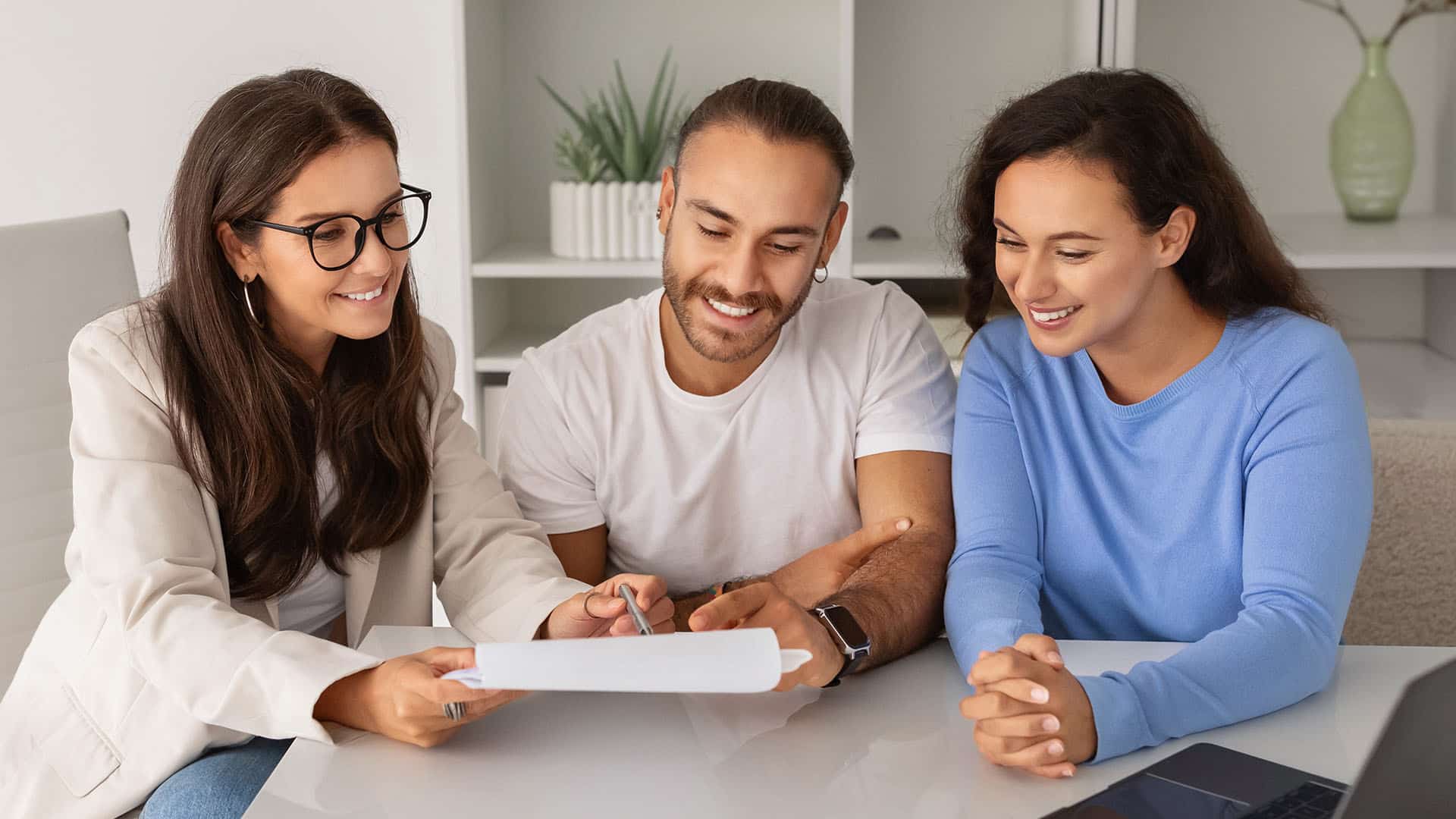 Mortgage broker reviewing financial documents with couple
