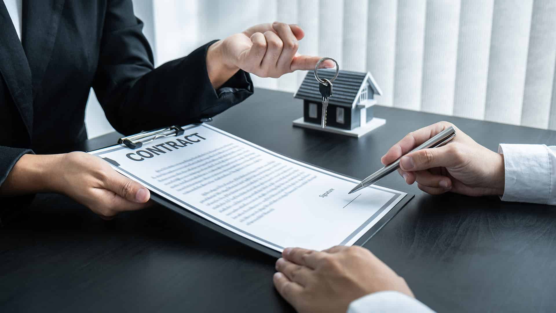Real estate agent reviewing closing contract with seller
