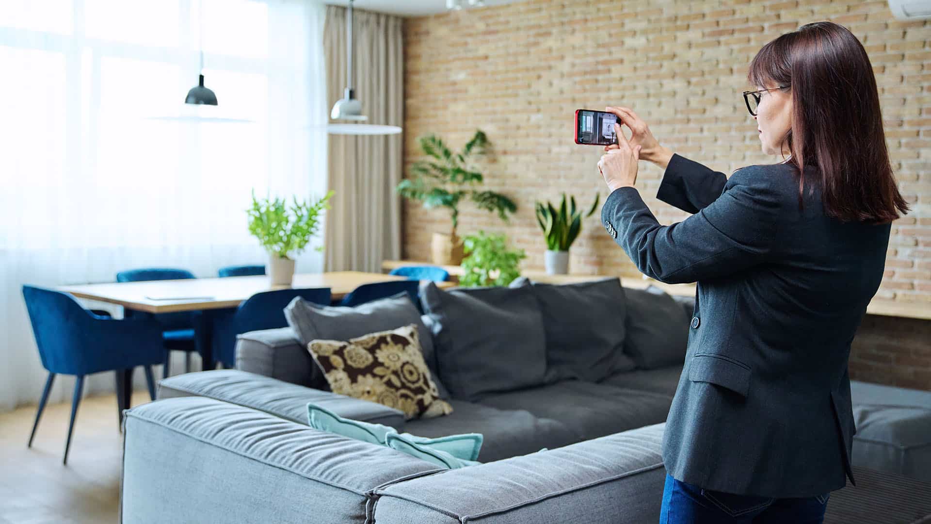 Real estate photographer taking photos of modern living room