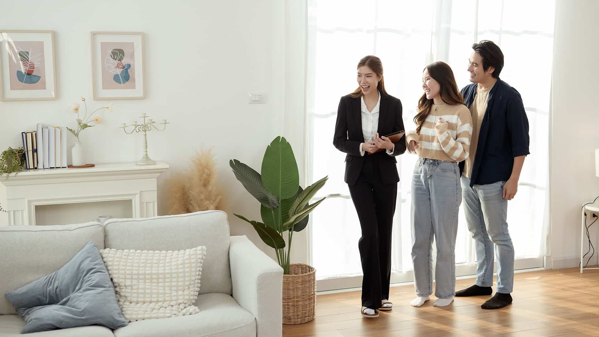 Realtor reviewing completed room design with happy clients