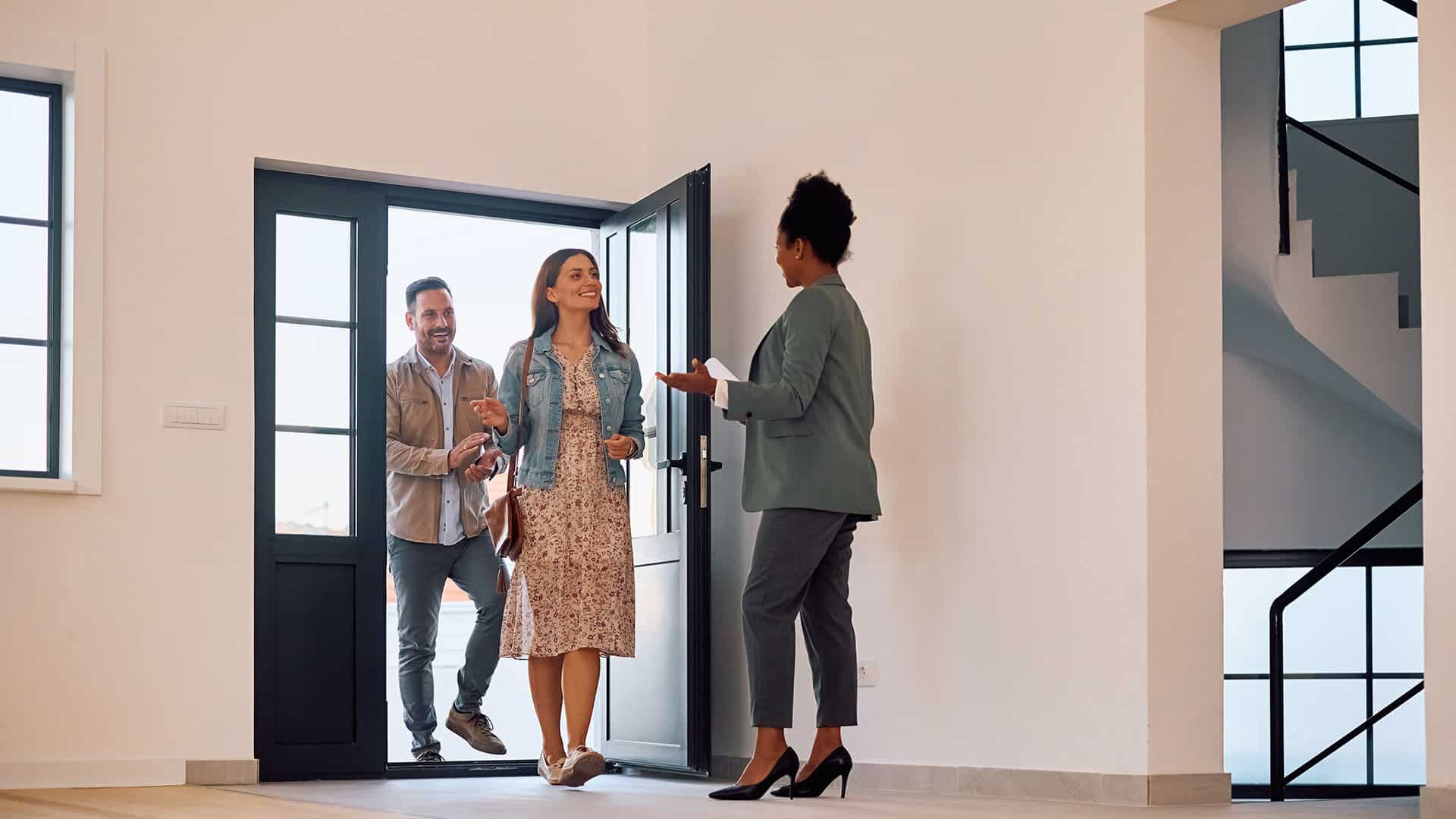 Realtor welcoming visitors open house modern home